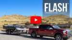 This video image for Fastway ISBM shows an extended-cab pickup towing a trailer with an classic muscle car on it.