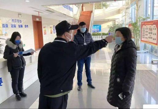 Picture of a Chinese factory working being scanned for the symptoms of the coronavirus