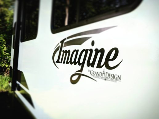 A photo of the Grand Design logo on the side of an Imagine RV