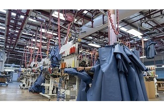 a photograph inside a Covercraft production warehouse where employees are making personal protective equipment for medical personnel
