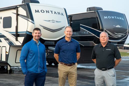 A photo of Colin Dechant, Jason Gill and Sam Lengerich of Keystone RV standing in front of two Montana fifth wheels.