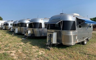 A picture of a group of Airstream trailers on a grassy field