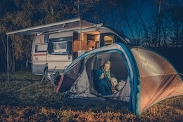 A picture of an RV and a tent