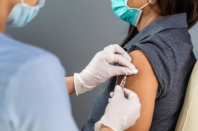A picture of a general woman getting a vaccine