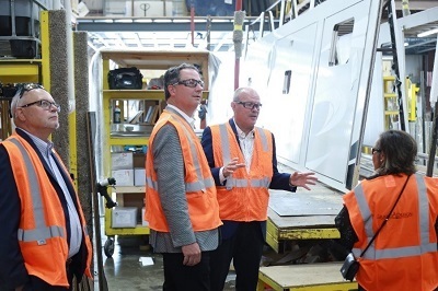 A picture of Doug Miller, Indiana State Representative for District 48; Todd Huston, Speaker of the Indiana House of Representatives' Don Clark, President and CEO of Grand Design RV; and Joanna King, Indiana State Representative for District 49; taking a tour of Grand Design's production plant in Middlebury, Indiana.