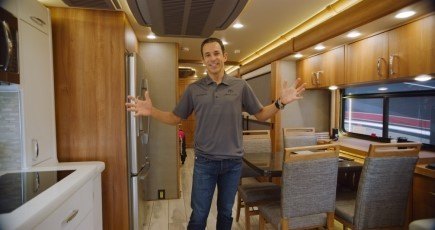 A picture of race car driver Helio Castroneves in the customized interior of his American Coach motorhome