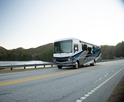A picture of a Fleetwood RV Bounder Type A motorhome driving down a road.