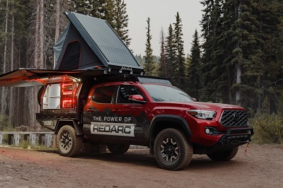 A picture of the Redarc Tacoma off road truck with tent for camping on top