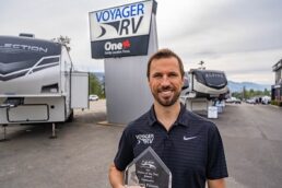A picture of Jason Friesen, dealer principal of Voyager RV Centre, with the RVDA of BC dealer of the year award.