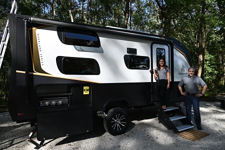 Ember RV President and CEO Ashley Bontrager and Vice President Chris Barth stand outside the exterior of a 2022 prototype RV