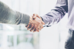 A picture of two people shaking hands on an agreement or deal