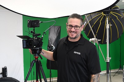 A picture of NRVTA Sales and Marketing Director Tony Flammia readying equipment for use in the green screen set in the new NRVTA studio
