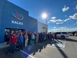 A picture of RV Retailer and Aloha RV employees gathered outside the building after RV Retailer bought Aloha RV