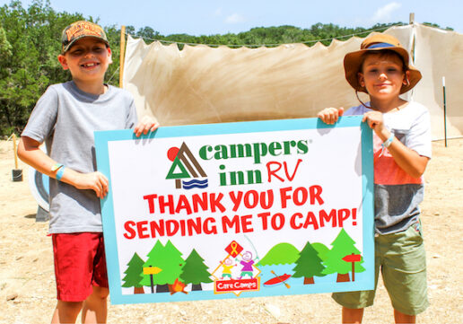 A picture of two kids holding a sign thanking Campers Inn RV.
