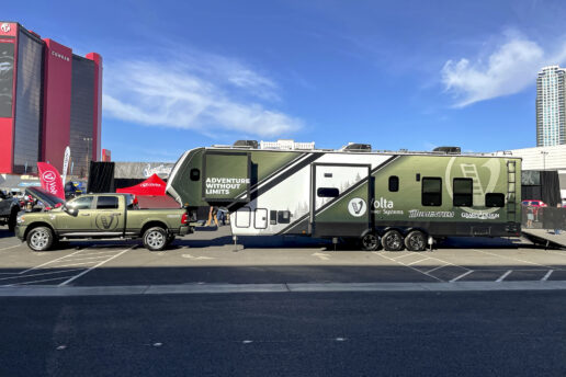 A picture of a Momentum fifth wheel that is retrofitted with a Volta power system and a custom wrap for the 2021 SEMA show.