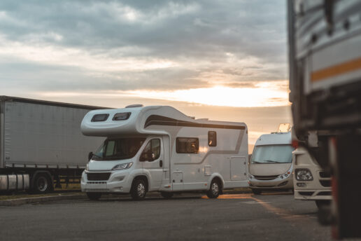 A Type C motorhome sits at a roadside rest stop.
