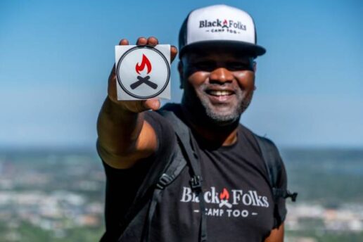 Earl B. Hunter Jr., founder of Black Folks Camp Too, is seen showing off the Unity Blaze logo during a hike.
