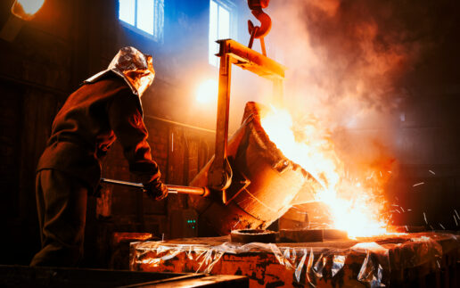 Worker controlling metal melting in furnaces.