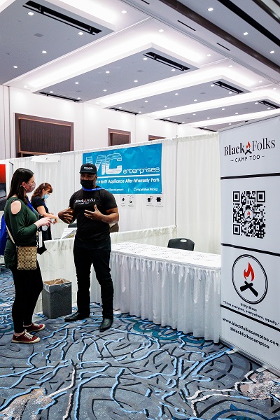 Black Folks Camp Too founder Earl Hunter talks to an attendee at the 2022 NTP-Stag Expo