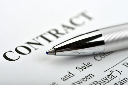 A stock image of a paper with a CONTRACT headline and a pen lying across the paper