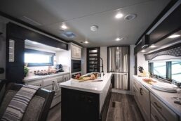A picture of the interior of a DRV Luxury Suites fifth wheel with a Halo RV voice assistant in the ceiling