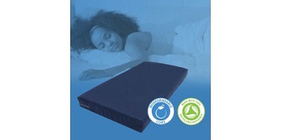 A picture of a woman sleeping in the background with Lippert's EnviroSpring biodegradable mattress in the foreground