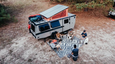 An aerial picture of friends sitting around outside a Taxa Outdoors Mantis Overload