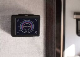 A picture of Elwell Corp.'s Timberline Heating System monitor installed on an RV wall