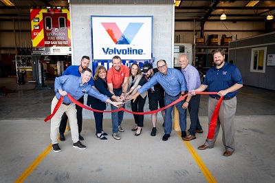 A picture of Valvoline staff cutting a ribbon at the grand opening of the supplier's heavy duty truck service center in Lexington, Kentucky.