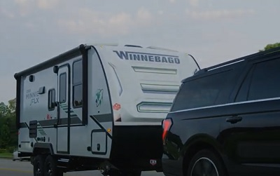 A picture of a vehicle towing a Winnebago Micro Minnie FLX travel trailer