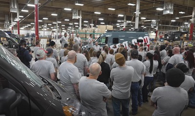 A picture of Winnebago workers at the manufacturing plant hearing from leadership about the company's 500,000th motorhome.