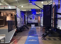 A picture of the indoor showroom with RVs on either side of an aisle at the RV consumer show in York, Pennsylvania