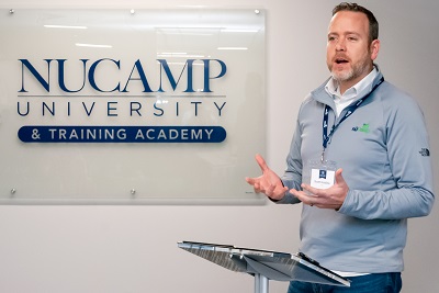 nuCamp CEO Scott Hubble talks at the inaugural class of nuCamp University training