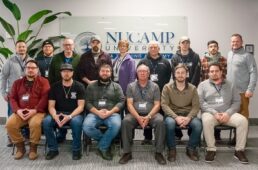 A class picture of the 14 students and instructor at the inaugural class of nuCamp University training