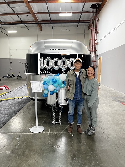 A picture of new owners of 10000th Airstream trailer