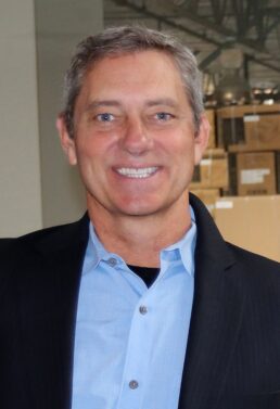 A picture of Bruce de Jong of AIMs Power in a button-up shirt and jacket.