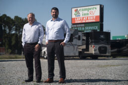 A picture of Jeff Hirsch and Ben Hirsch standing outside a dealership