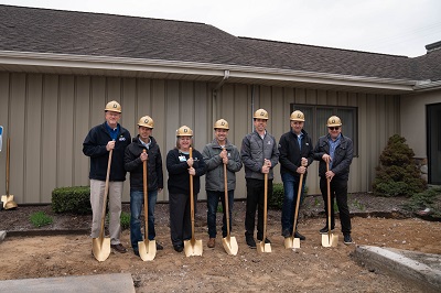 A picture of seven people with hardhats and shovels at a health clinic groundbreaking event.