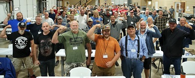 A picture of a large group of people, some posing with biceps flexed at RV Fundamentals class