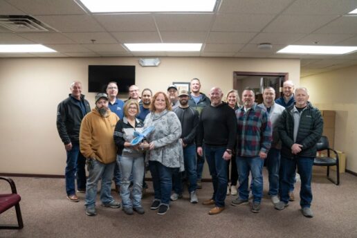 A picture of the Betterway Products staff showcasing their Jayco Blue Excellence Award.