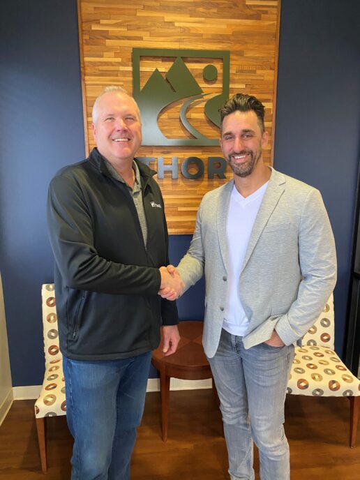 A picture of Bob Martin and Jeremy Stutsman shaking hands.