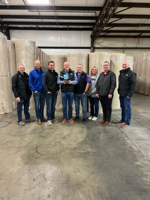 A picture of the Brianza USA Corp staff showcasing their Jayco Blue Excellence Award.