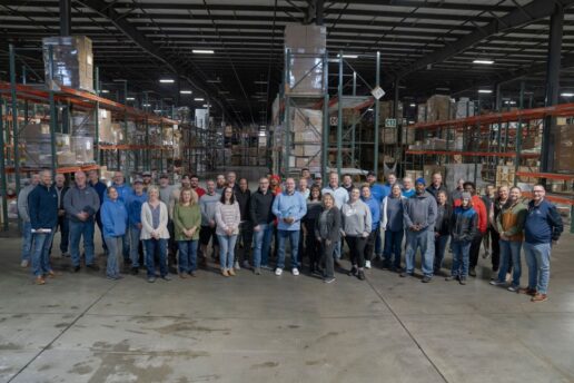 A picture of the Dave Carter & Associates staff showcasing their Jayco Blue Excellence Award.