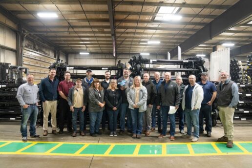 A picture of the Dexter Axle staff showcasing their Jayco Blue Excellence Award.