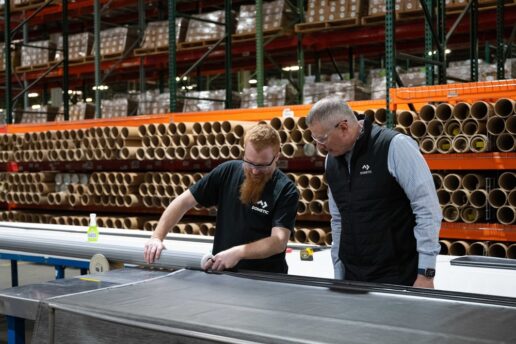 A picture of Segment Land Vehicle Americas President Todd Seyfert (R) watches Dometic's Andrew Hoff (L) place fabric at Dometic's awning manufacturing plant in Elkhart, Indiana.