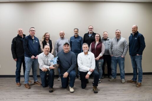 A picture of the Global Distribution Link staff showcasing their Jayco Blue Excellence Award.