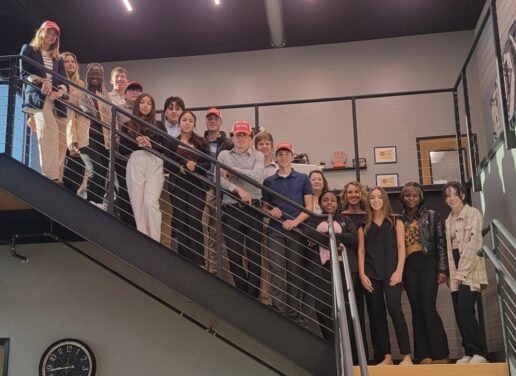 A picture of Startup Moxie students on a staircase at Grand Design RV's facility.
