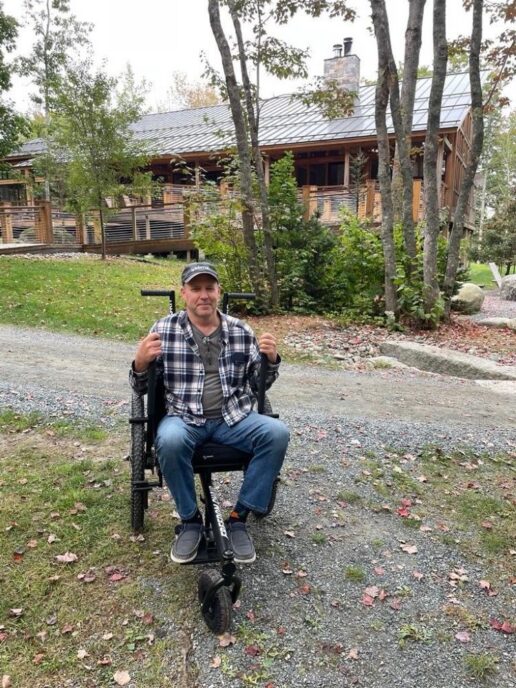 A picture of a consumer using the Grit Freedom Chair on a gravel path.