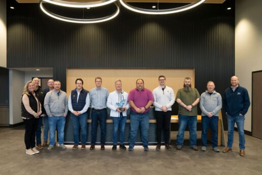 A picture of the MJB Wood Group staff showcasing their Jayco Blue Excellence Award.