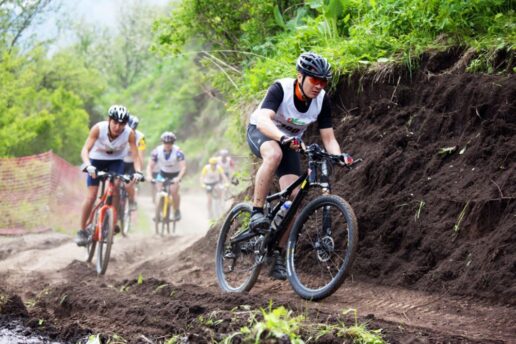 A picture of cyclists biking through a trail.